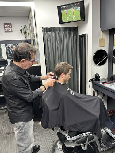  Owner Joe Micale at work making his magic and producing another great hair style at 'The Barber Room' one of Brisbane City's most popular inner city CBD Traditional Barber Shop located in Blocksidge Arcade, Adelaide Street, Brisbane.