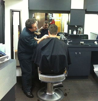 Joe Micale at work advising on the best individual hair styling for one of his younger clientelle.